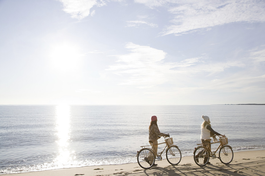 Women by the sea with bicycles